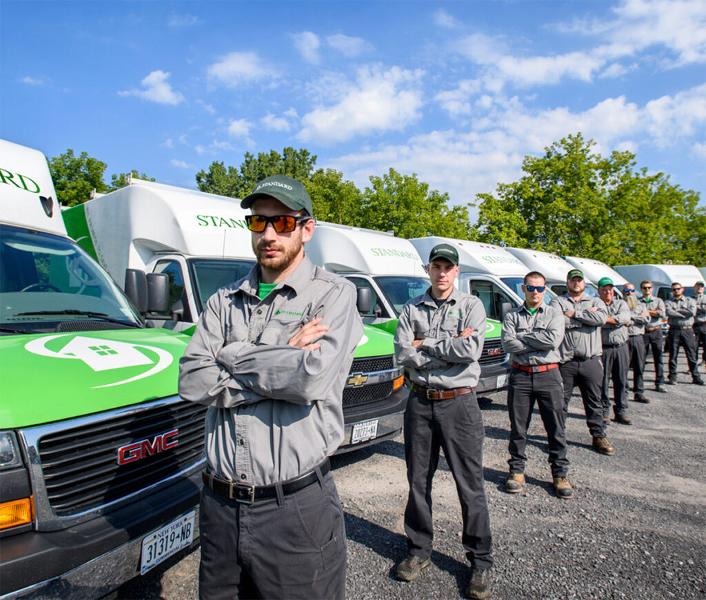 Standard technicians standing next to Standard trucks