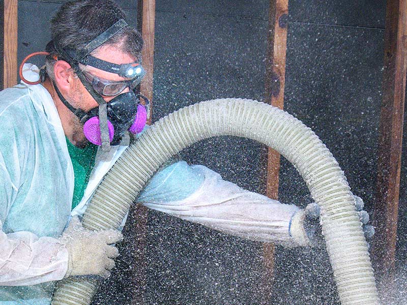 Standard technician blowing insulation