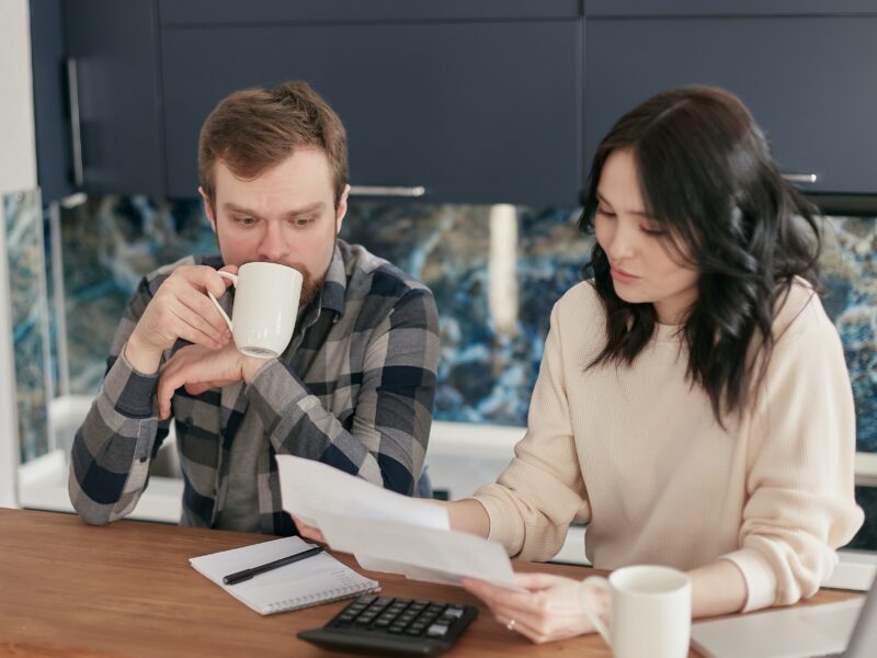 New York couple reviewing utilities bills and making a plan for how they can save money by participating in rebates and grants