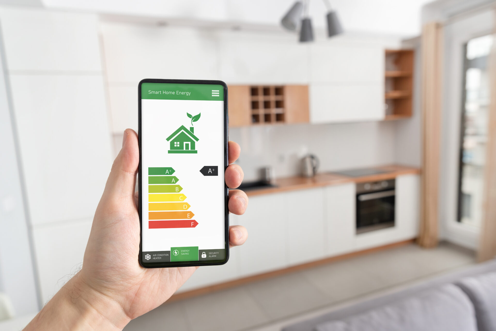 energy efficiency mobile app on a smartphone screen with a kitchen in the background